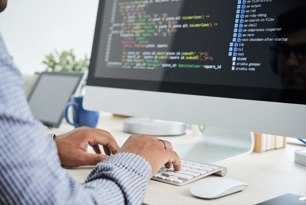 Close up of man working with code on computer