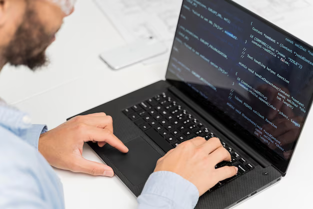 Man working on software code on his laptop